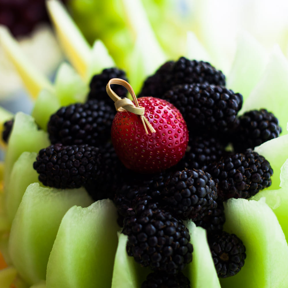 Blackberries and a single strawberry set into the centre of a carved honeydew flower.